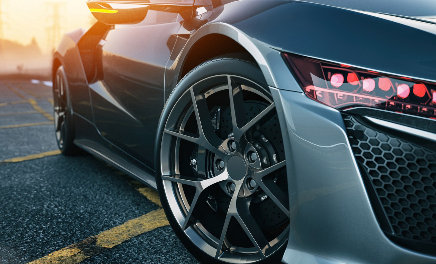 Close-up of a sleek sports car with detailed alloy wheels and aerodynamic design.